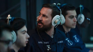 Martin Compston as a navy officer, wearing headphones