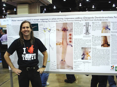 Presenter, Zen Faulkes, in front of a poster.