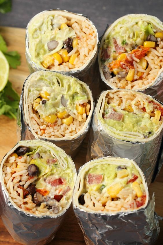 A vegan burrito recipe that is super filling, hearty, flavorful and every kind of delicious! Stuffed with black beans and corn, rice, vegan sour cream and guacamole, this is a recipe you'll return to again and again