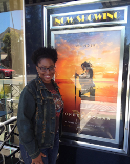 Jenee Darden posing with Wonder Woman poster after watching the movie.  