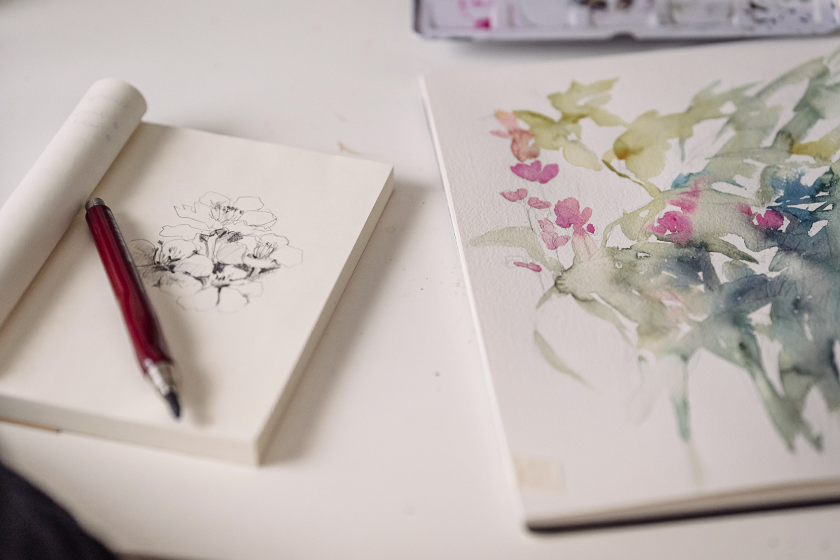 close-up of two art journals filled with watercolor paintings