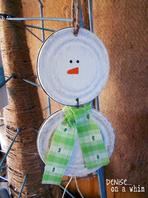 Adding a touch of white paint to a couple of jar lids to create a snowman ornament