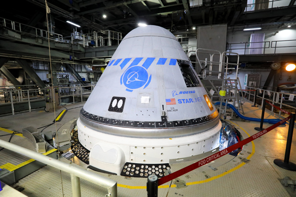 The CST-100 Starliner, still attached to its Atlas V rocket, sits inside the Vertical Integration Facility at Cape Canaveral Space Force Station's Space Launch Complex 41.