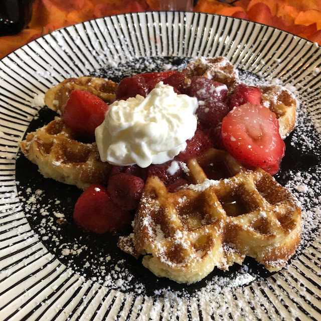 Delightful fresh Belgian waffles topped with syrup, berries, whipped cream and powdered sugar at Guardian Angel Bed and Breakfast. Yum!