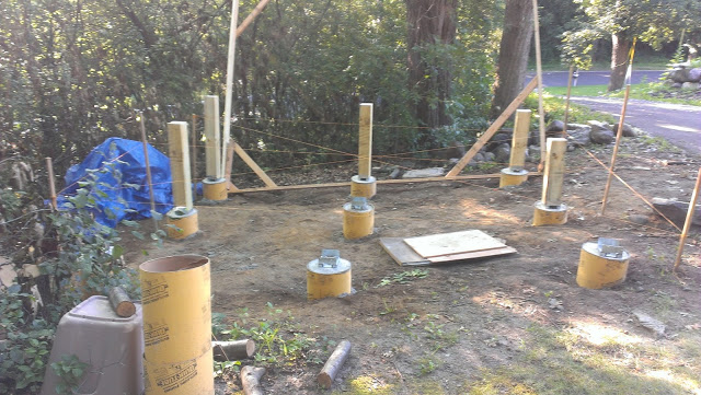Sauna build site with string line and foundation posts.