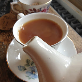 tea pot spout and cup of tea