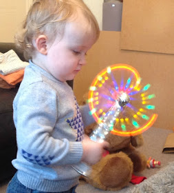 toddler playing with glow stick windmill