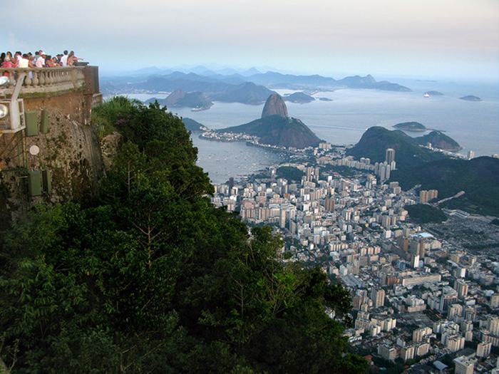 Sugarloaf Mountain, is a peak situated in Rio de Janeiro, Brazil, at the mouth of Guanabara Bay on a peninsula that sticks out into the Atlantic Ocean. Rising 396 metres (1,299 ft) above the harbor, its name is said to refer to its resemblance to the traditional shape of concentrated refined loaf sugar.