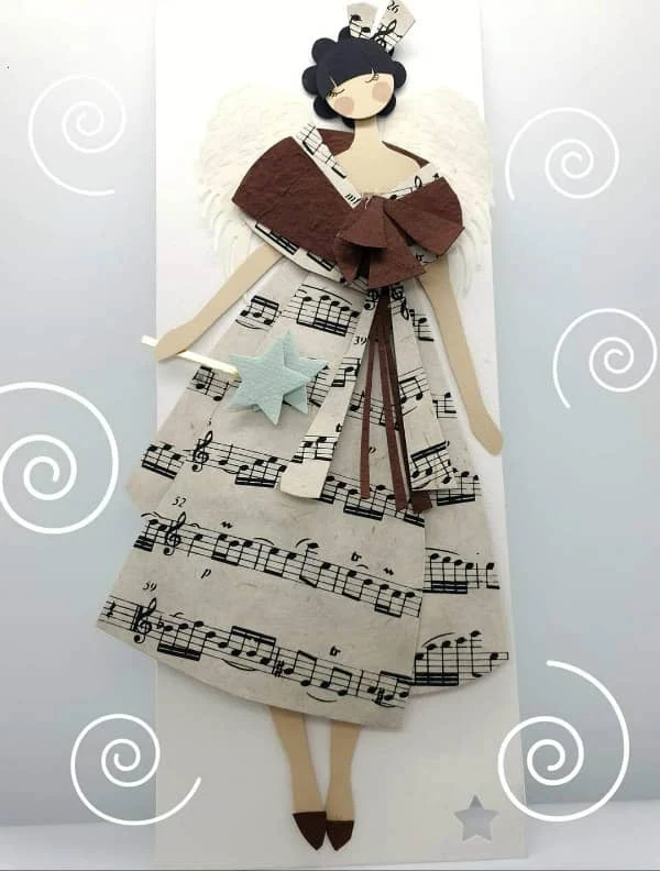 papercut figure of young woman dressed in musical notes skirt holding star wand