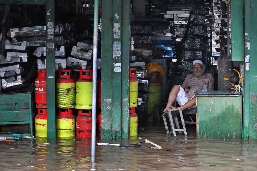 18 Devastating Pictures Of The Flooding In South Asia That Will Shock You - A Bangladeshi Man Sits In His Flooded Shop After Heavy Rain In Dhaka