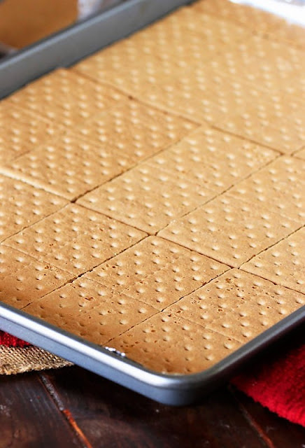 Laying Out Graham Crackers in Pan to Make Cracker Candy Image