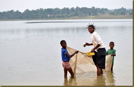 Kids catching fish with net