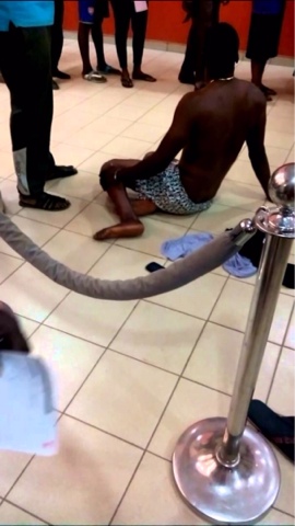 man strips in Nigerian bank