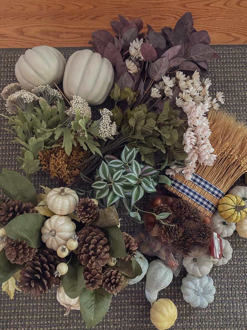 collection of faux fall leaves, painted pumpkins, decorative fall floral arrangements, and fall branches