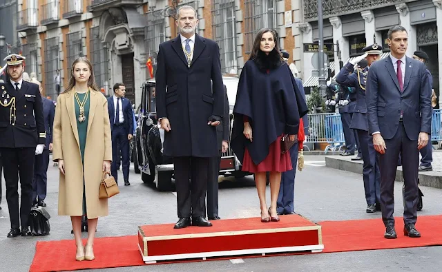 Princess Leonor wore a green a-line dress by Adolfo Dominguez, and camel double-faced wool coat by Carolina Herrera