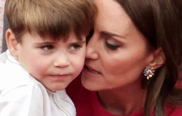 Kate Middleton wore a red bespoke dress by Stella McCartney. Queen Elizabeth, Prince George, Princess Charlotte and Prince Louis