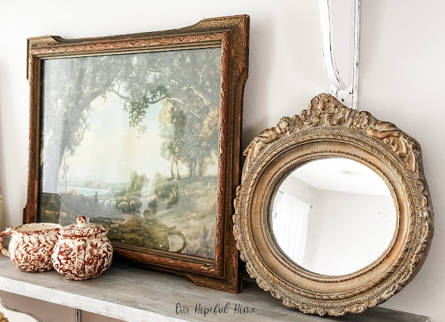 gilded mirror and vintage landscape painting