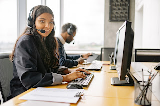 photo of black call center reps smiling at camera.