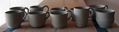 Image of ten clay mugs in their greenware stage