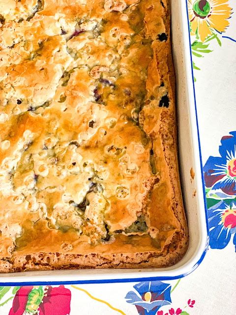 These delightful Blueberry Gooey Butter Cake Bars have the perfect combination of flavors, the ease of the recipe, and the ease of carrying it somewhere.   Perfect for any celebrations, picnics, potlucks, or grand enough for any dinner party.