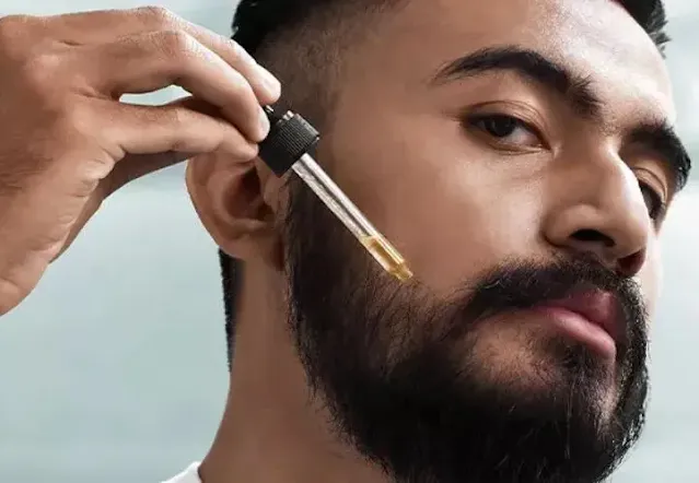 A black beard man using beard oil