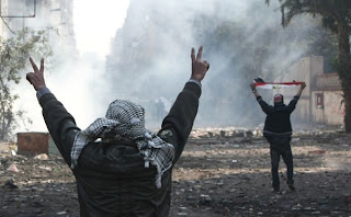 Egyptian protesters flash the V-sign for victory during clashes