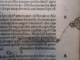 The margins of a printed page, with a drawn hand holding a string attached to one of the lines. 