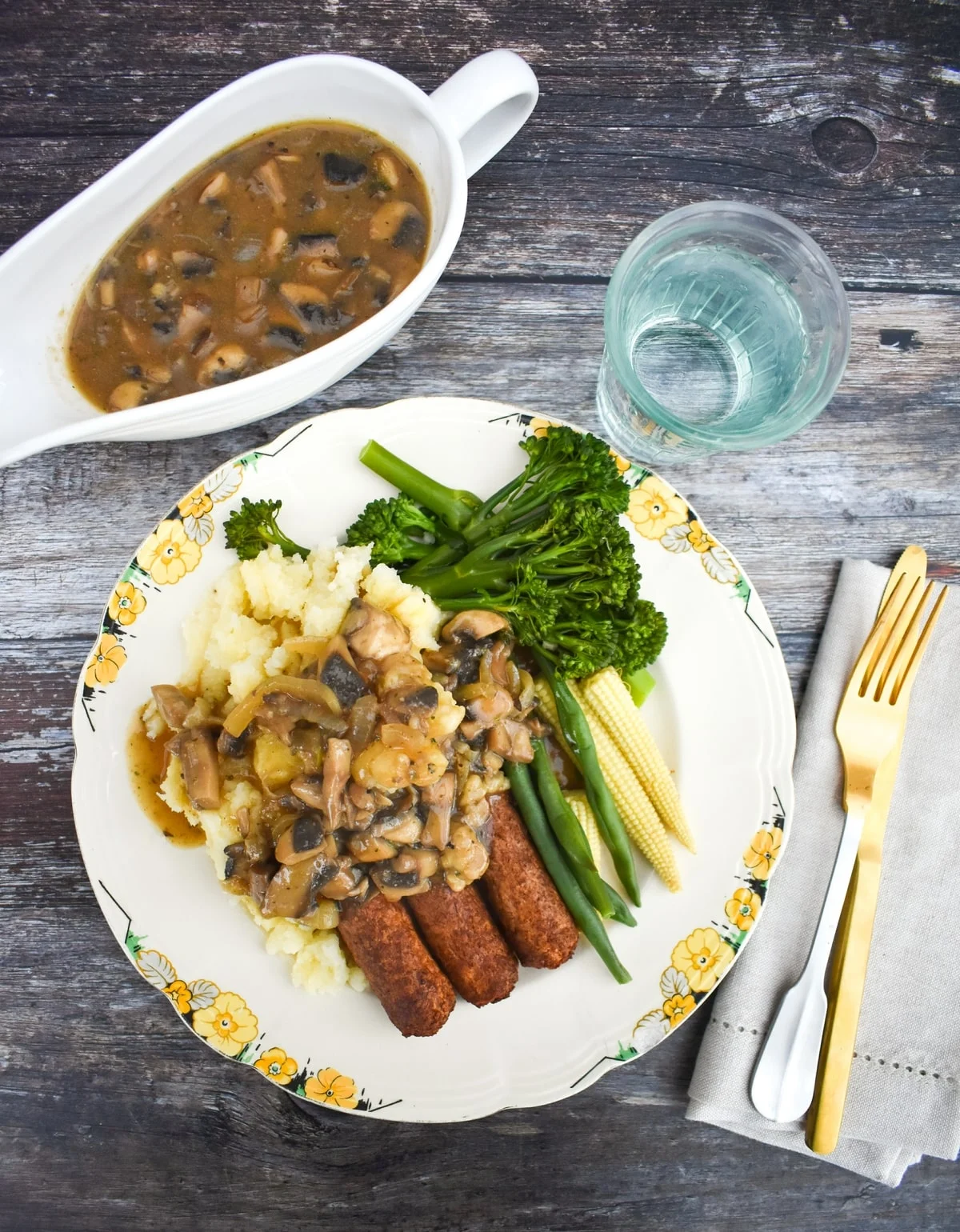 homemade gravy served with vegan sausages, mash & veg