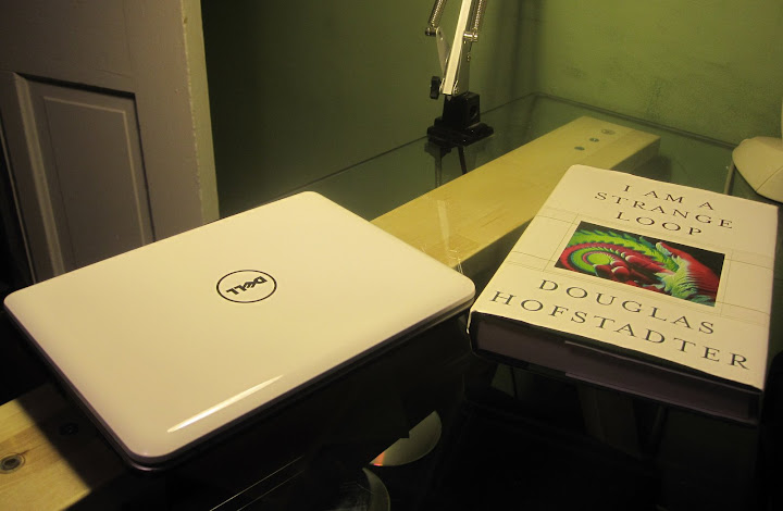 Dell Mini 9 next to an exemplar hardback