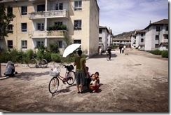 NORTH KOREA. The Stark Reality.  A family huddle together in Kaesong city near Panmunjom in the Demilitarized Zone between North and South Korea. 2009