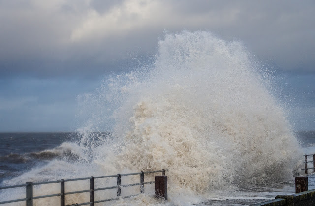 Photo of a giant wave crashing onto Maryport Promenade