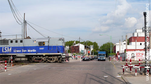 One of the blue trains of Linea San Martin at a railroad crossing in the Palermo neighborhood, Buenos Aires