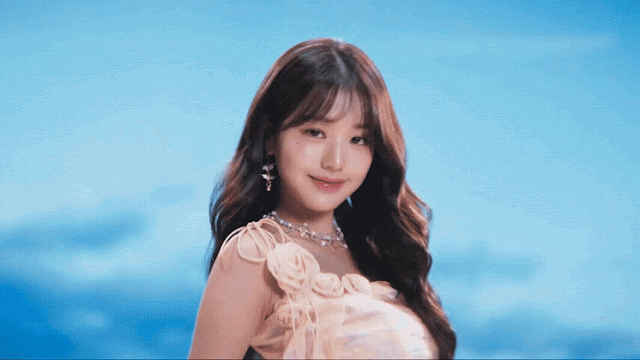 Gif from IVE's music video for their song Crush that shows fast-paced shots of the members looking at the camera with a background that looks like a cloudy sky.