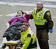 Sadness: An unidentified Boston Marathon runner leaves the course crying . (boston )