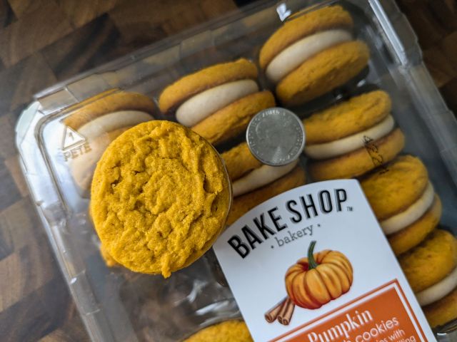 A Aldi's Bake Shop Pumpkin Sandwich Cookie next to a quarter.