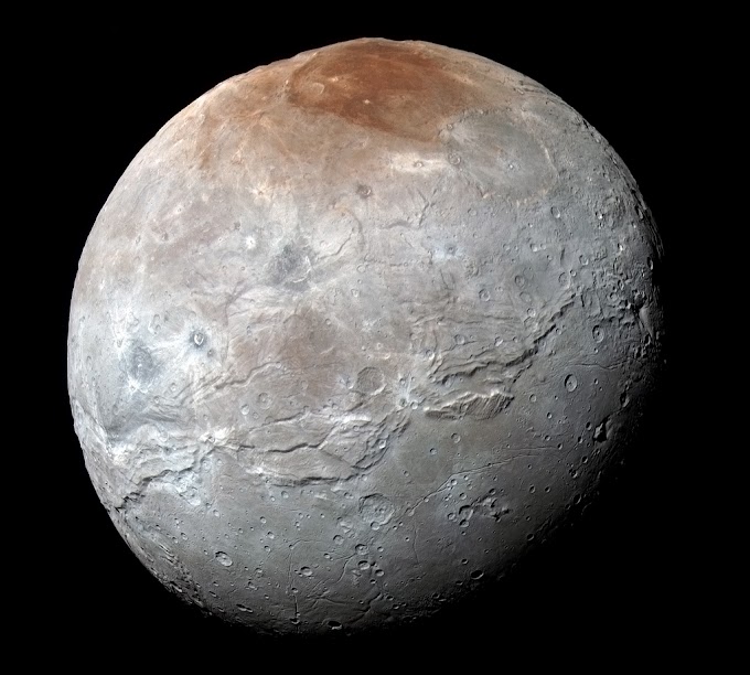 Warna Kemerahan Di Bulan Planet Pluto Charon Terungkap