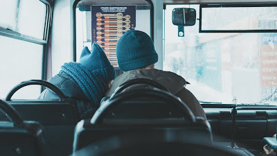 Woman leans on man sitting next to her on bus