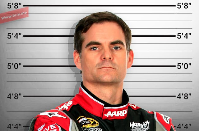 Jeff Gordon standing in front of a height chart