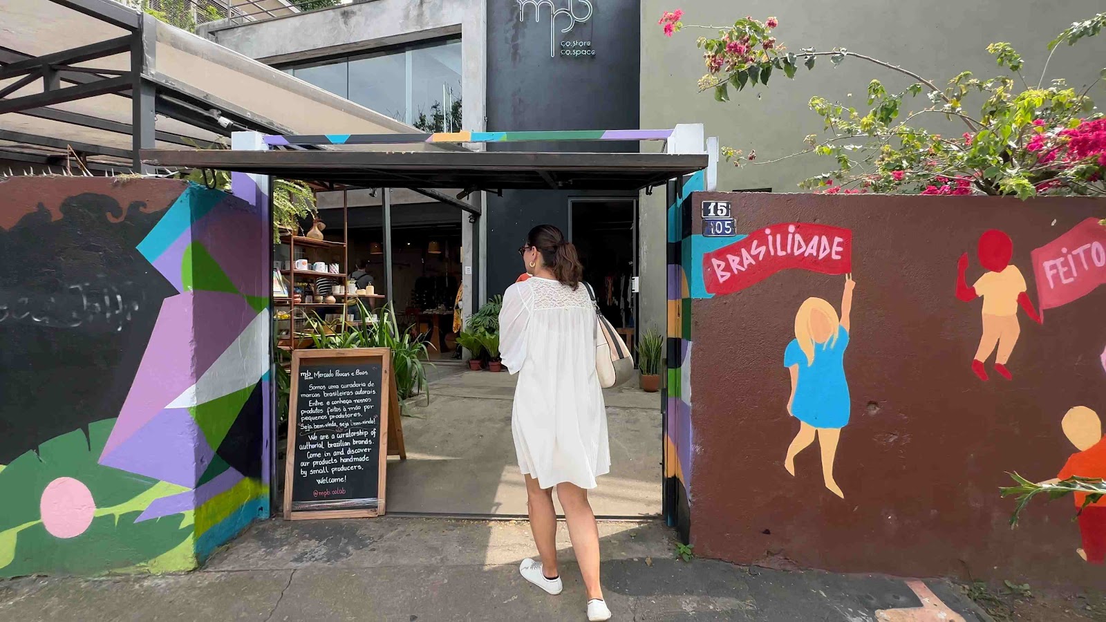The inviting entrance of a shop selling unique art decorations, with colorful murals on the walls.