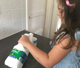 daughter poring a mug of Arla Goodness milk in the kitchen 