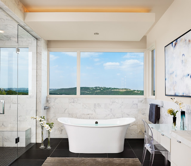 Photo of modern bathroom with bathtub by the window