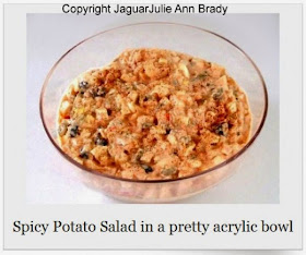 spicy potato salad in pretty acrylic bowl