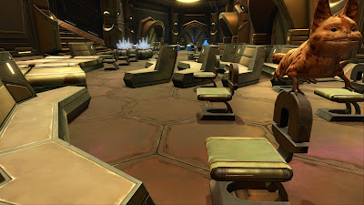 A room in a Nar Shaddaa stronghold filled with basic metal benches and chairs stacked right next to each other