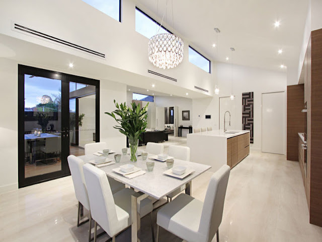 Picture of modern dining room by the kitchen with white chairs and modern table