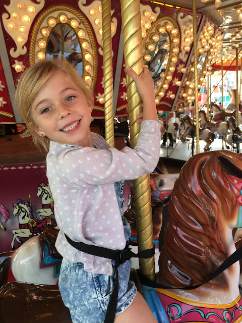 Little girl on Merry Go Round at the Carnival at the Houston Rodeo
