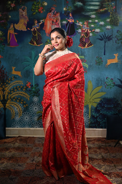 Red Banarasi saree which is inspired from gharchola and patola. It has bandhini work also.