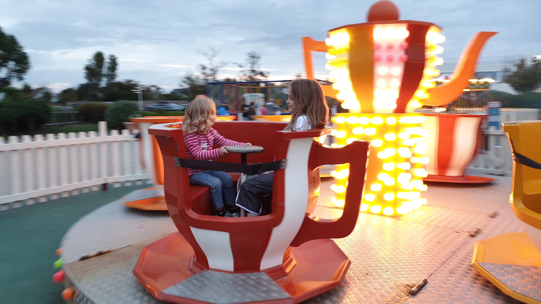 kids in a teacup fairground ride