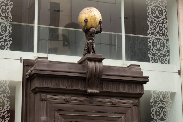 Statue holding globe over head