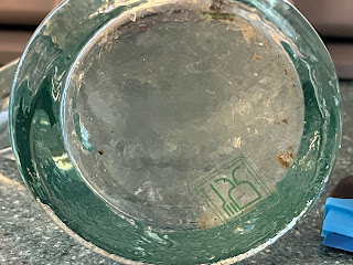 Old sticker mostly removed from bottom of pitcher