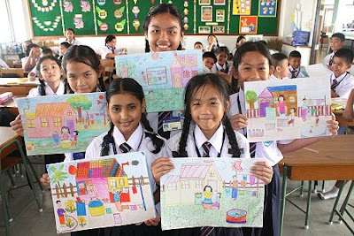 A picture of children in at school in Thailand holding their artwork